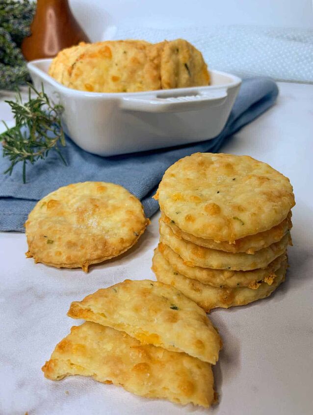 homemade cheddar cheese crackers, Cheddar crackers stacks on a board and in a white casserole dish
