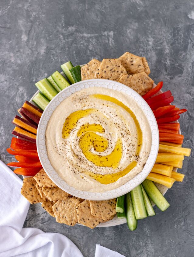 the best classic homemade hummus, The Best Classic Homemade Hummus on a platter with vegetables and crackers