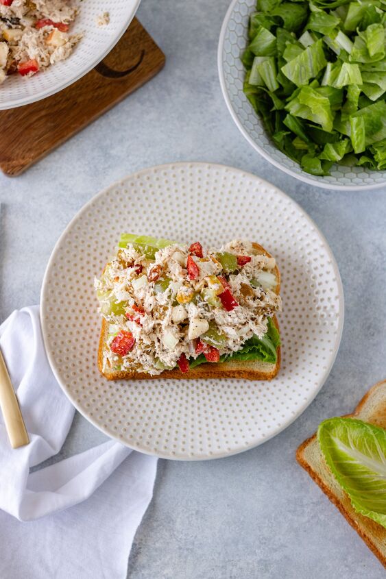 easy chicken salad recipe, Shredded chicken diced apple bell pepper onion grapes and raisins mixed with mayo and sitting on a piece of lettuce and toasted bread