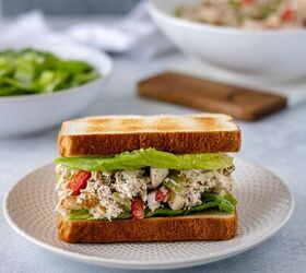 easy chicken salad recipe, Easy Chicken Salad in between two slices of toasted bread and sitting on a ceramic plate