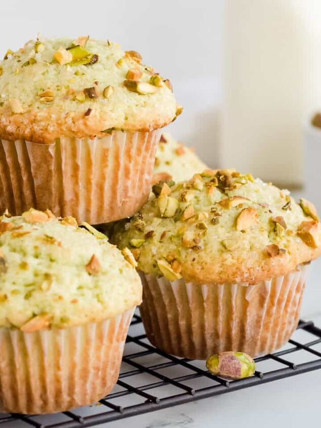monkey milkshake, Pistachio muffins stacked on wire rack with a glass of milk and a bowl of pistachios in background
