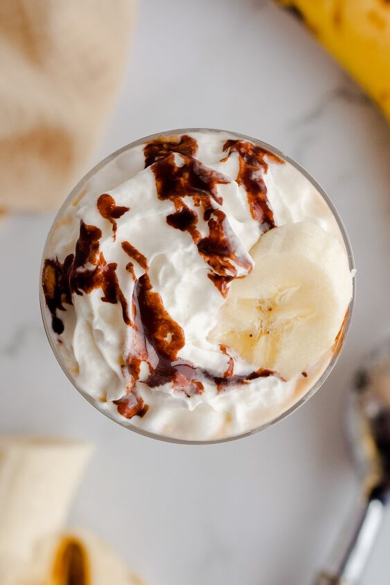 monkey milkshake, Overhead view of milkshake with whipped cream chocolate syrup and banana slice