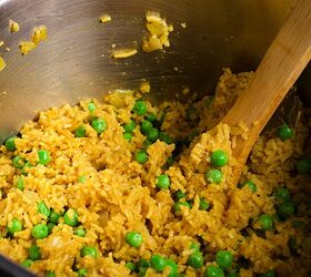 Stirring a pot of Indian Rice with peas