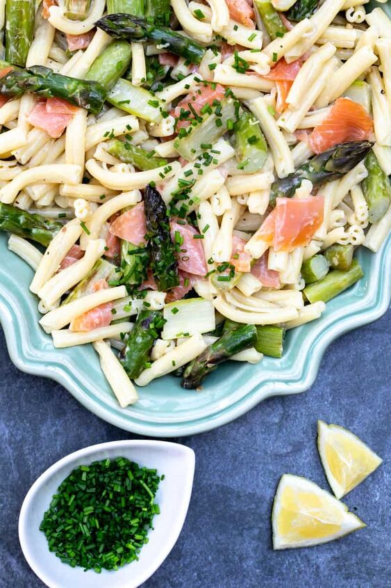 smoked salmon and asparagus pasta, platter with smoked salmon and asparagus pasta next to bowl of chives and lemon wedges