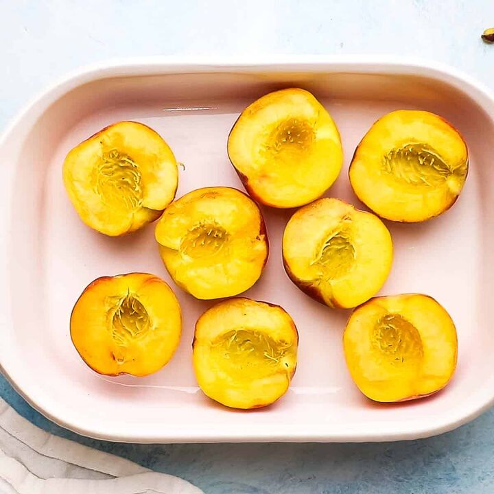 roasted peaches with pistachio crumble, Halved peaches in a baking dish