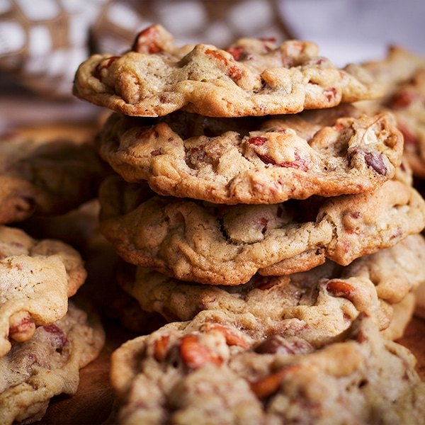 A stack of Anything Cookies on a tray with other cookies all around