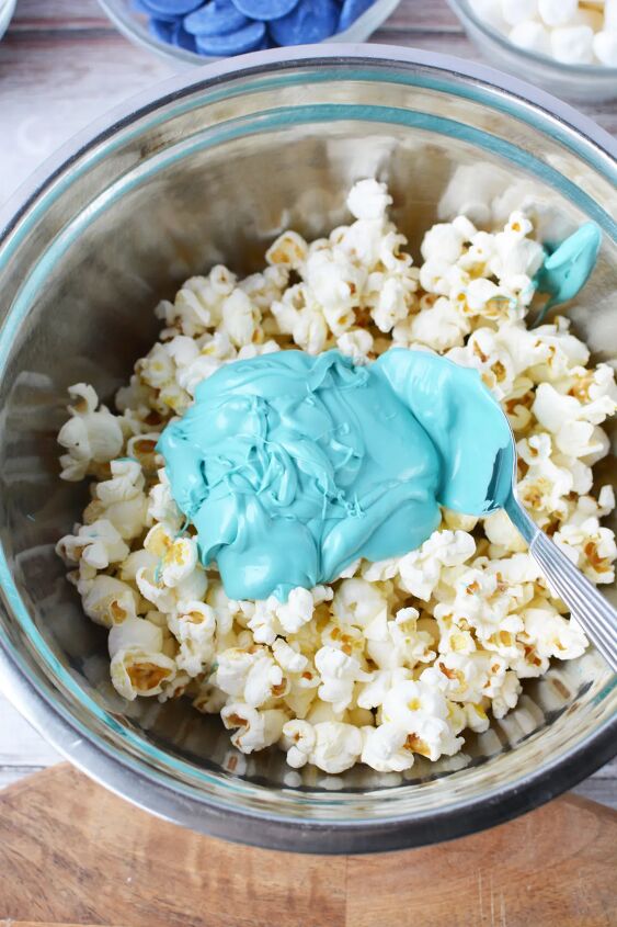 Blue melted candy in a bowl with plain popcorn
