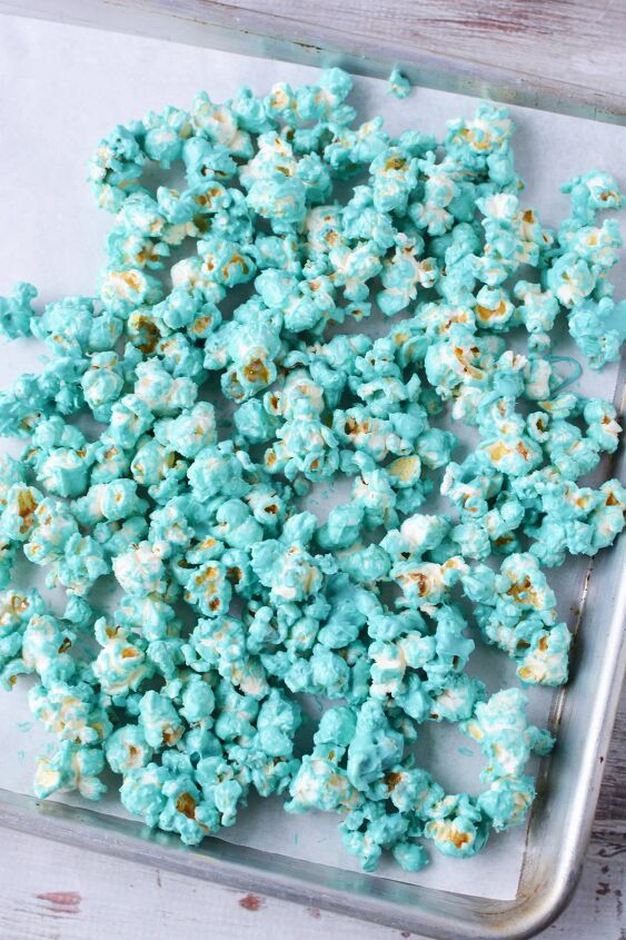 Candy coated blue popcorn on a baking sheet