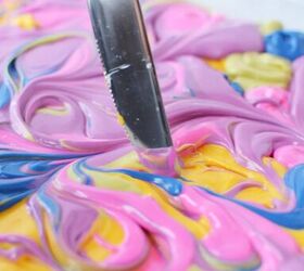 easy diy rainbow bark candy recipe, Dragging a knife through candy melts to swirl