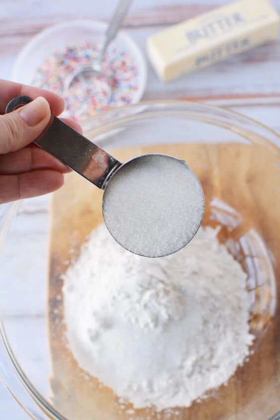 adorable fairy shortbread bites 100 mini cookies, Adding sugar to flour in a bowl