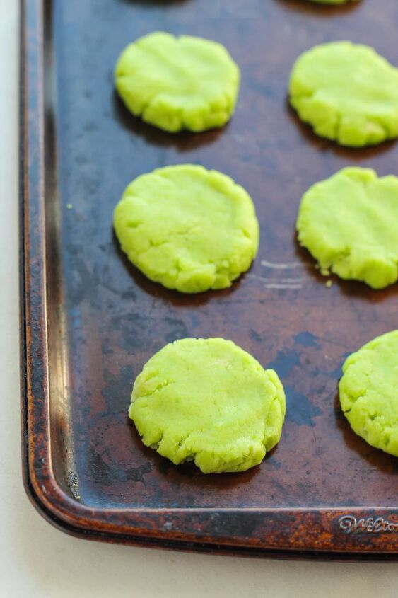 Flattened green cookie dough on a baking sheet