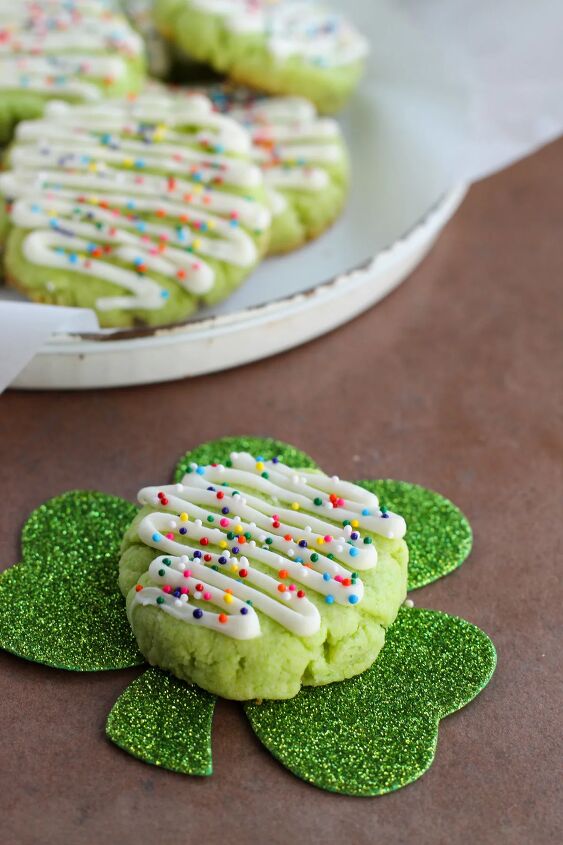 Green cookies with sprinkles One sitting on a shamrock decoration