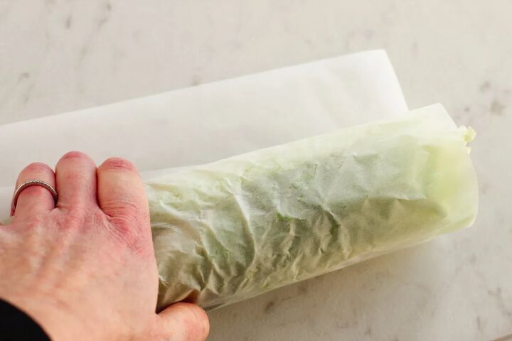 tasty low carb turkey club wrap recipe, Rolling a lettuce wrap in parchment paper