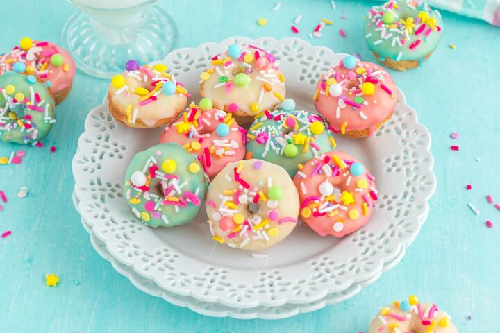 bright and delicious mini donuts with colorful glaze little fairy do, A plate of colorfully glazed mini donuts with sprinkles