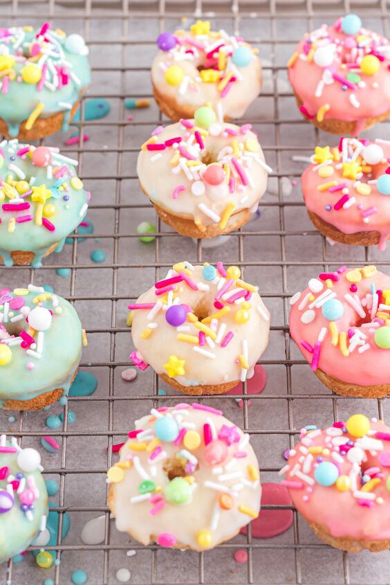 bright and delicious mini donuts with colorful glaze little fairy do, Blue yellow and pink glazed donuts on a cooling rack