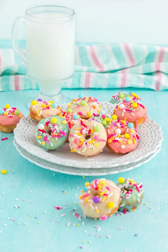 bright and delicious mini donuts with colorful glaze little fairy do, Mini donuts glazed in colors on a plate next to a glass of milk