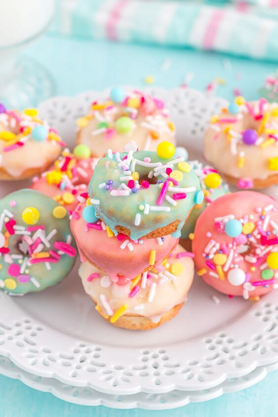 bright and delicious mini donuts with colorful glaze little fairy do, Plate full of tiny donuts with blue yellow and pink glaze and sprinkles