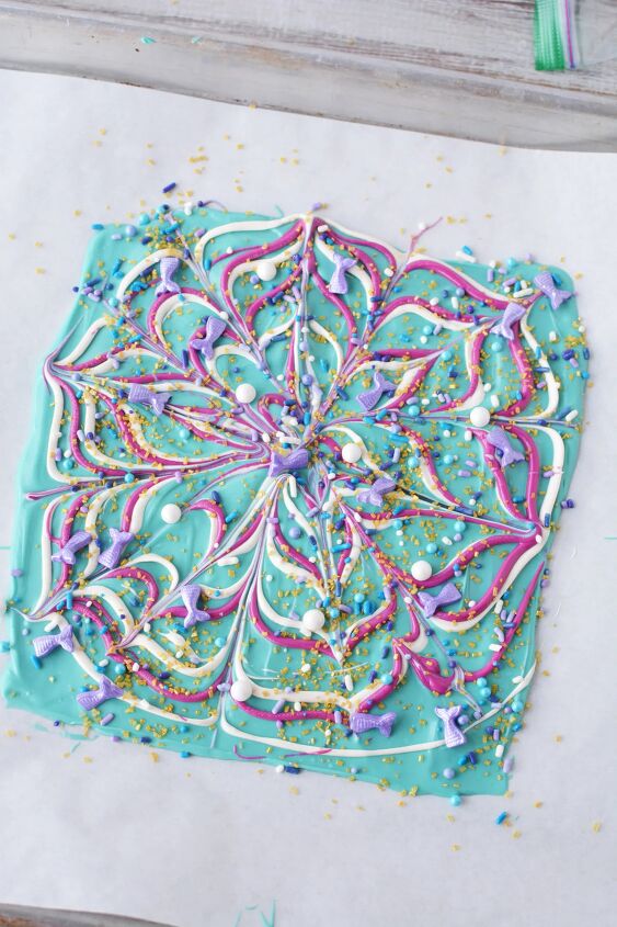 sparkly mermaid bark candy for an easy under the sea sweet, Swirls of candy melts and sprinkles on parchment paper on a sheet