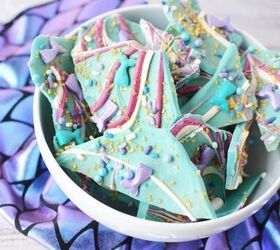 sparkly mermaid bark candy for an easy under the sea sweet, Bowl of mermaid candy bark pieces on top of mermaid fin scale fabric