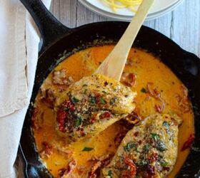 marry me chicken the perfect recipe for a delicious and hearty dinner, Skillet with a wooden spoon lifting out a piece of Marry Me Chicken