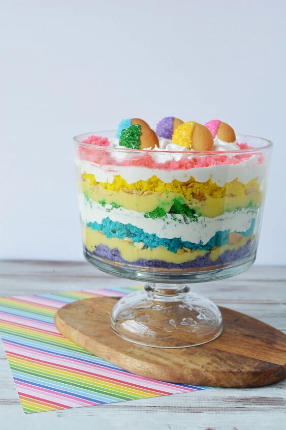 how to make a rainbow trifle dessert for a magical party, Rainbow trifle in a bowl on a board