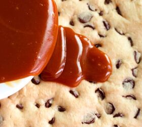 salted caramel chocolate chip cookie bars recipe, Pouring caramel sauce over a baked chocolate chip cookie