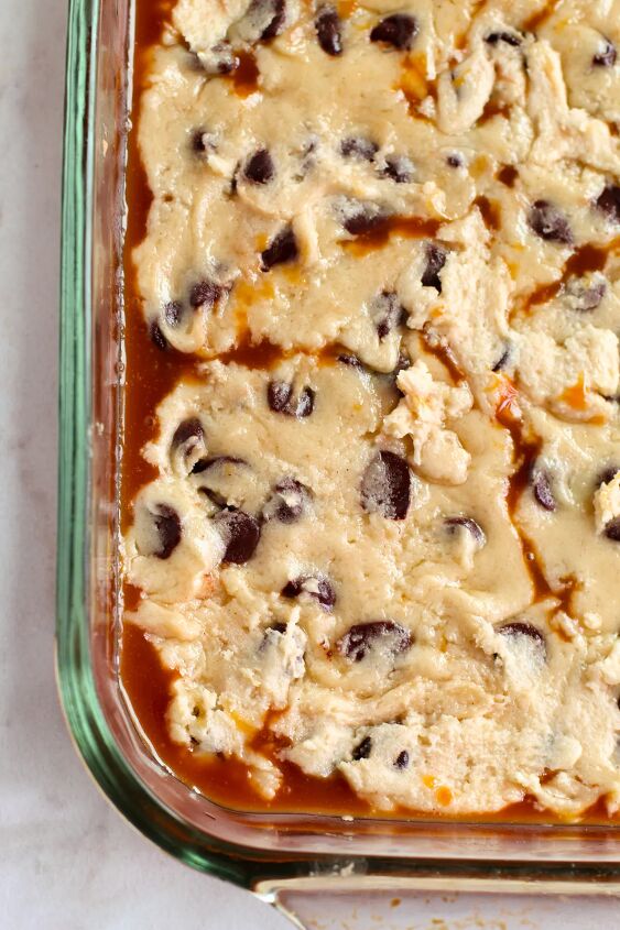 salted caramel chocolate chip cookie bars recipe, Cookie dough on top of a layer of caramel in a baking dish
