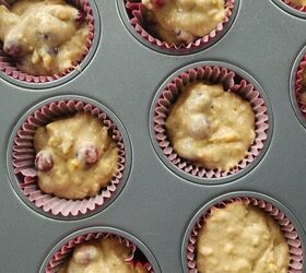 best cranberry walnut muffin recipe with orange marmalade, muffin tin with cranberry walnut muffin batter in it