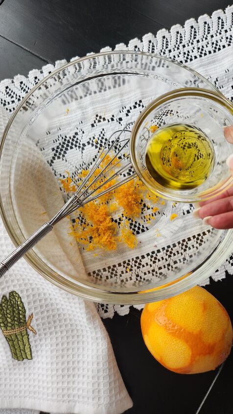 scallop salad recipe with orange honey walnut vinaigrette, olive oil in glass bowl being added to orange zest