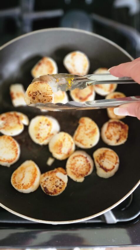 scallop salad recipe with orange honey walnut vinaigrette, scallops being browned in non stick pan