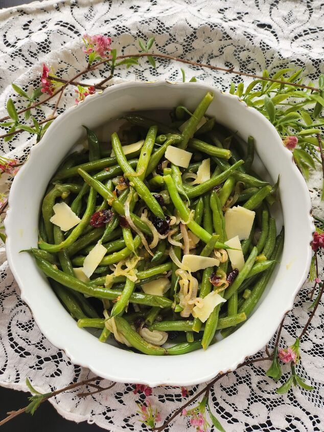 easy vegetarian green bean recipe with garlic, overhead of vegetarian green beans with shaved cheese and cranberries