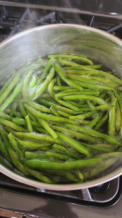 easy vegetarian green bean recipe with garlic, overhead view of green beans in pot of water