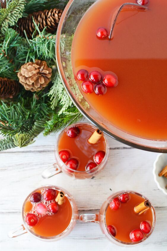 cranberry and cinnamon christmas punch recipe, Glasses of punch next to the punch bowl