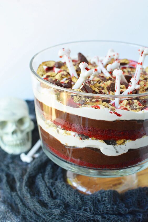 vampire red velvet trifle recipe, Vampire trifle topped with bones and next to Halloween decor on a table