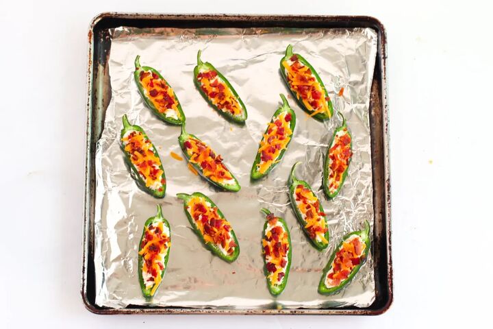 easy bacon jalapeno poppers appetizer, Jalepeno poppers on a baking sheet with foil