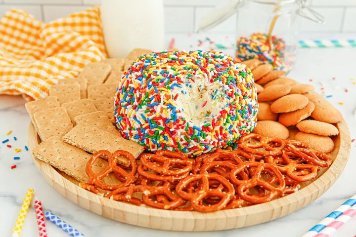 funfetti cream cheese ball dip, Cream cheese ball covered in sprinkles on a plate with pretzels graham crackers and cookies