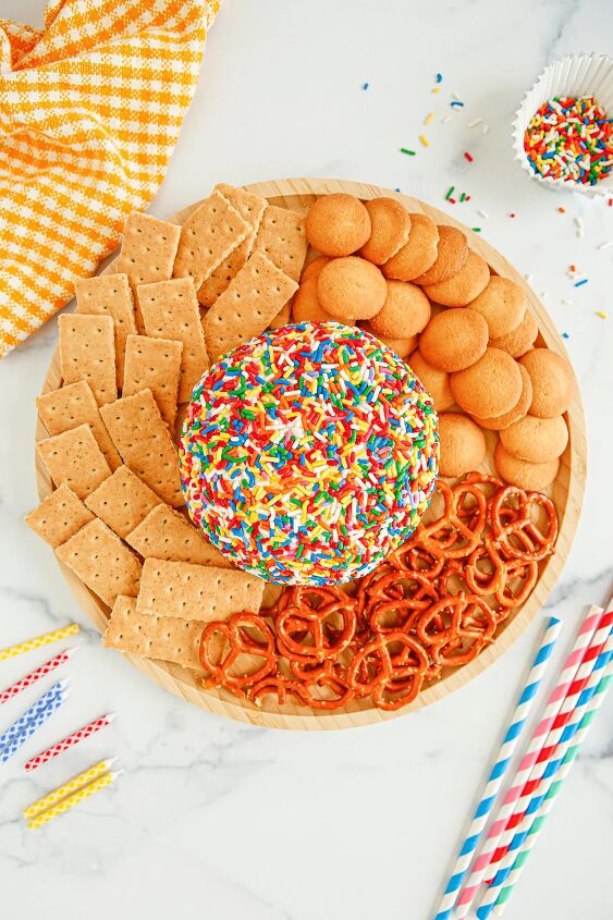funfetti cream cheese ball dip, Funfetti cheese ball in the middle of a plate surrounded by pretzels graham crackers and nilla wafers