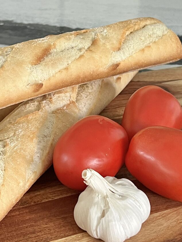 a simple and easy bruschetta baguette appetizer recipe, A french bread baguette with Roma tomatoes and a head of garlic