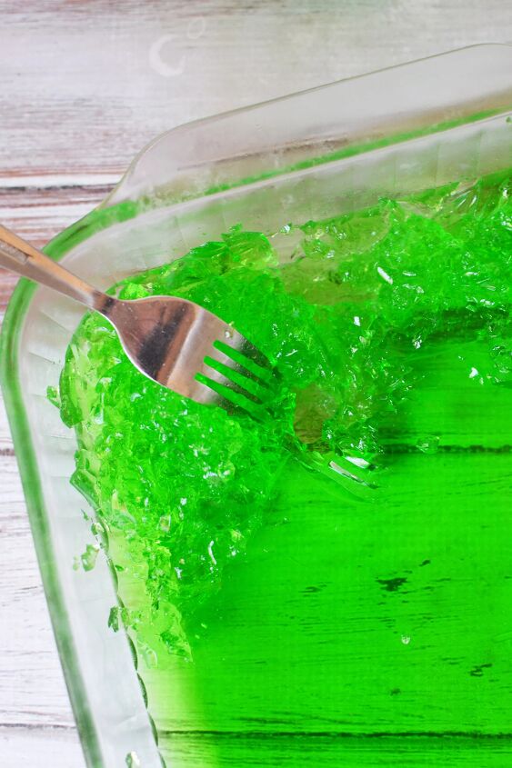 goblin goo green halloween punch, Using a fork to shred green jello