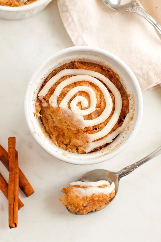 microwave cinnamon roll cake recipe, Cake with a spoonful taking out with the spoon next to it