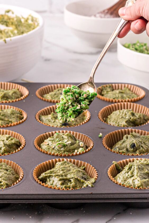 moldy banana halloween muffins recipe, Topping muffins with green crumble in a muffin tin