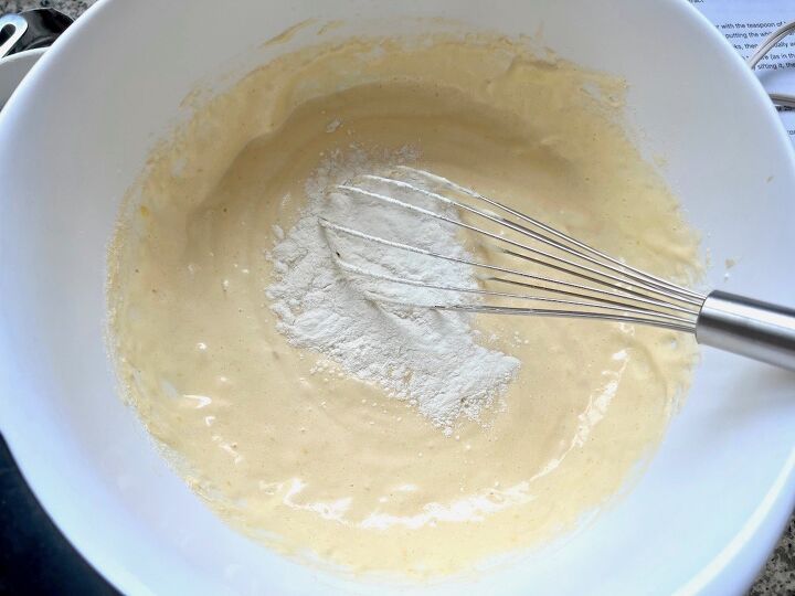 brazilian coconut cake bolo de coco, Sifted flour being whisked into batter for Brazilian Coconut Cake