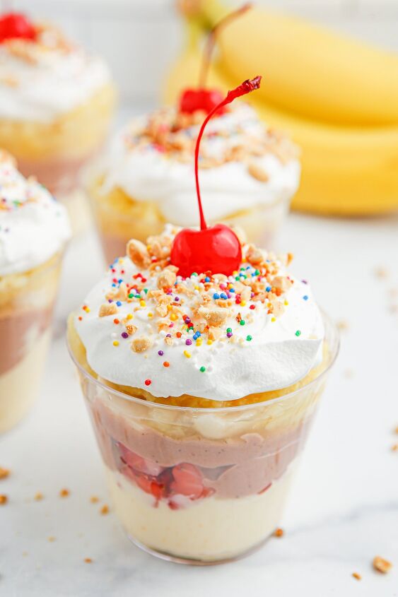 no bake banana split pudding cups recipe, Banana split pudding parfait cups topped with whipped cream cherries and crushed peanuts