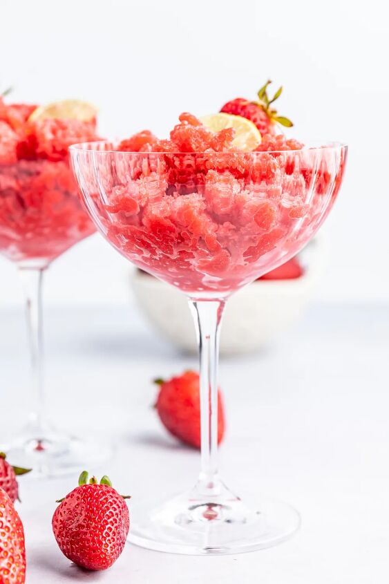 frosty and fresh strawberry lime granita, Strawberry granita in a glass with strawberries on the table