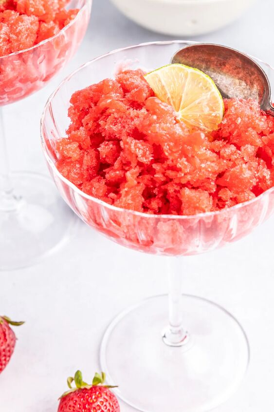 frosty and fresh strawberry lime granita, A glass of strawberry granita topped with a slice of lime
