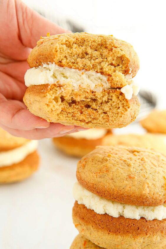 fluffy carrot cake whoopie pies, Holding a carrot whoopie pie with a bite taken out of it