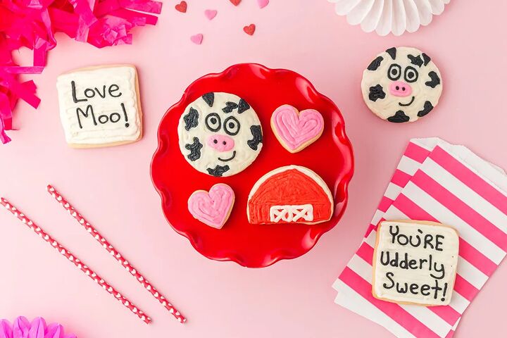 udderly sweet cow valentine sugar cookies, Valentine sugar cookies on a red plate One cow one barn two hearts with other cookies on the table