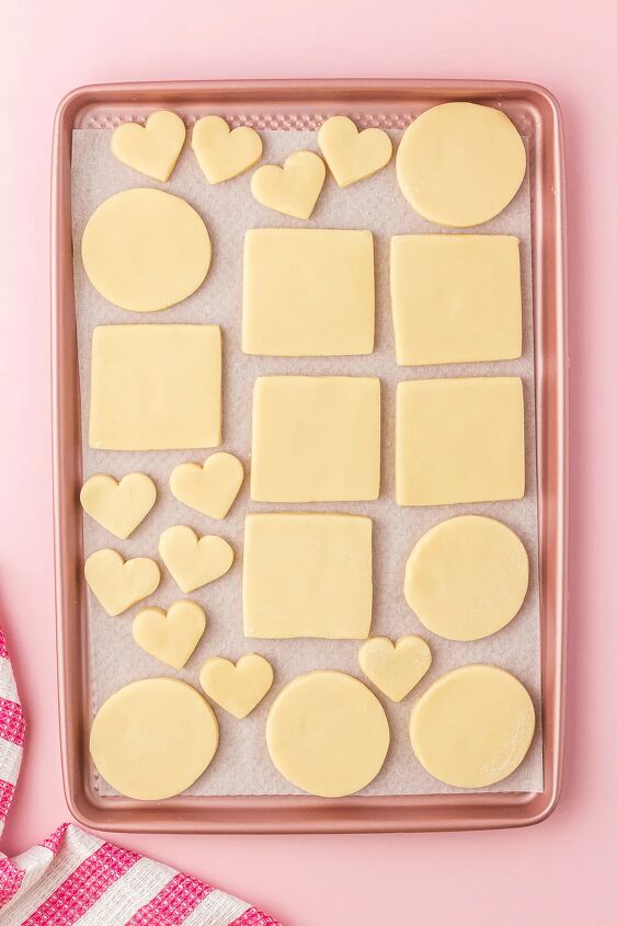 udderly sweet cow valentine sugar cookies, Dough cut into shapes and sitting on a cookie sheet