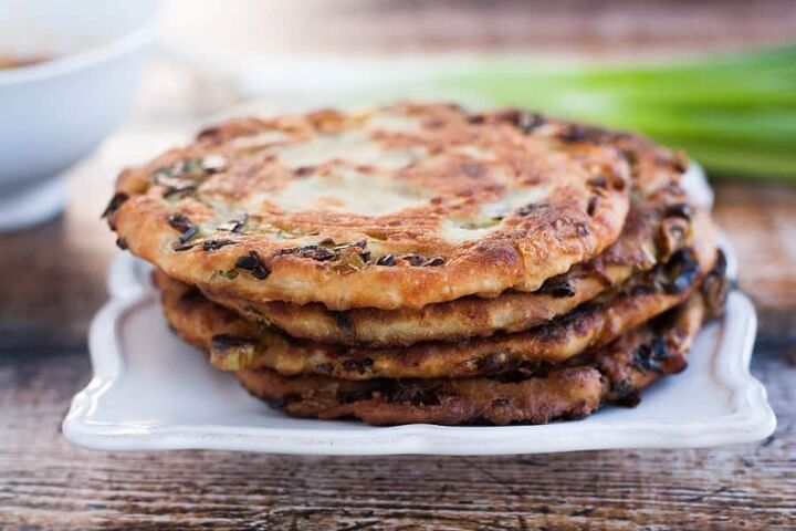 crispy scallion pancakes, crispy scallion pancakes stacked on a serving platter