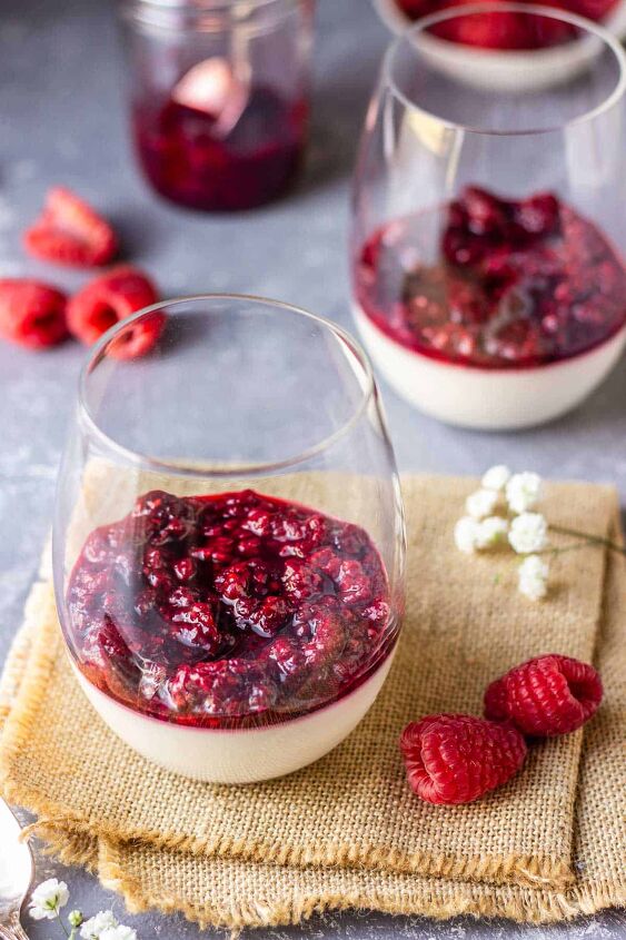 easy vegan raspberry panna cotta without gelatin, 3 glasses filled with coconut panna cotta and raspberry sauce